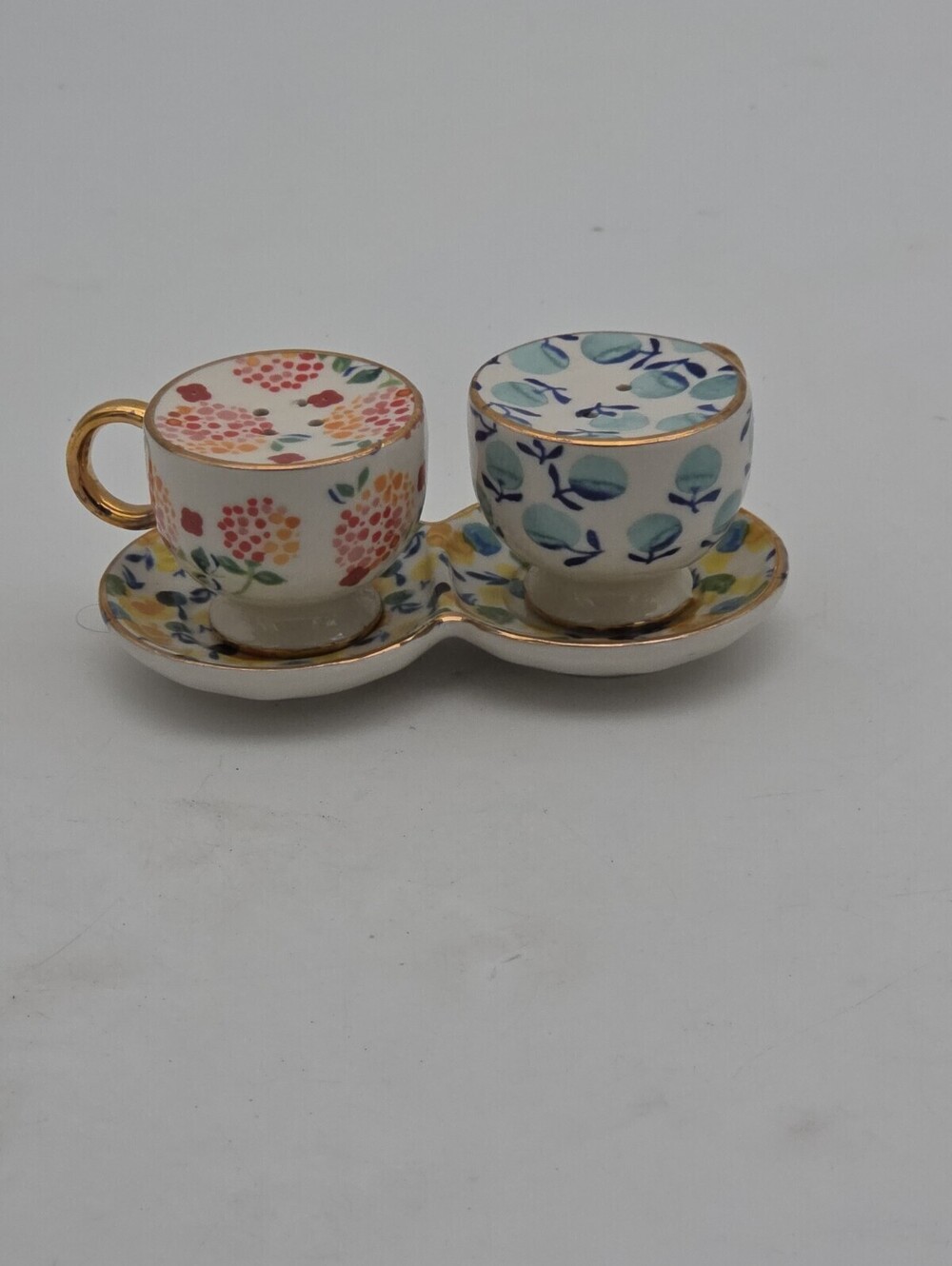 Anthropologie Aurora gilded floral teacup shaker set. 1 cup chipped (see photos)
